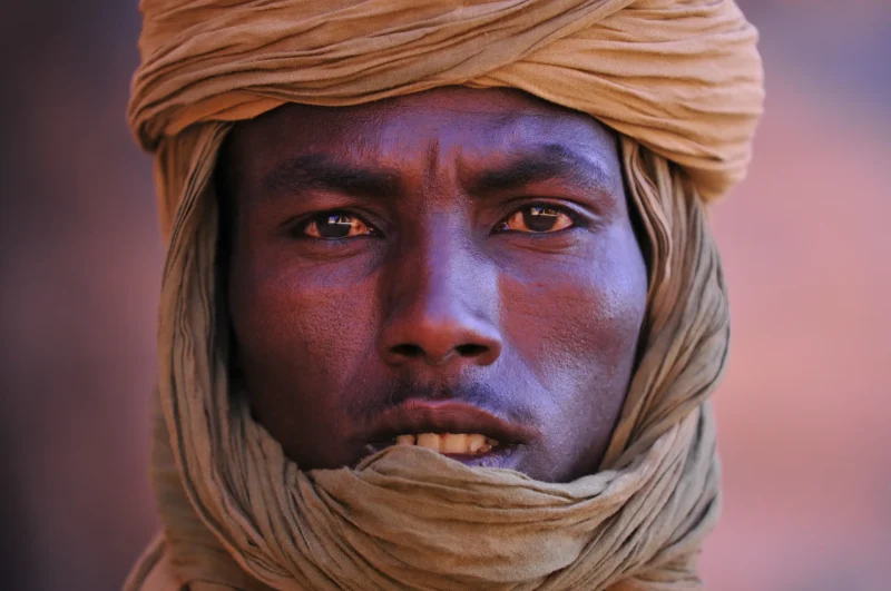 A Toubou man, with a determined look, wearing a typical scarf in the Ennedi desert.
